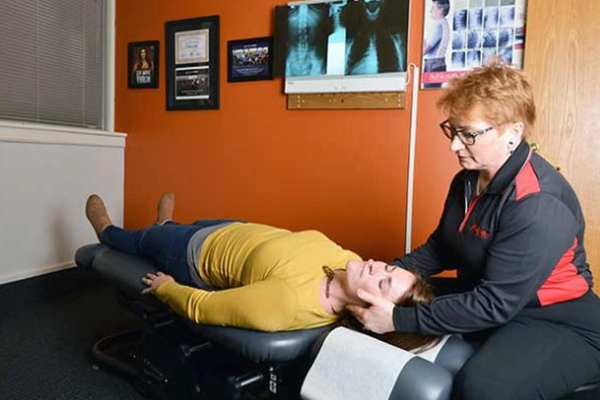 Chiropractor Roseville MN Patricia Wolff Adjusting Patients Neck