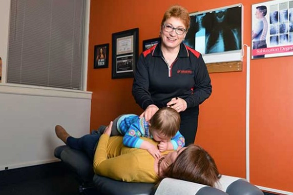 Chiropractor Roseville MN Patricia Wolff With Pediatric Patient & Mother