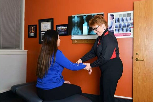 Chiropractor St Paul MN Trish Wolff Examining Patients Arm