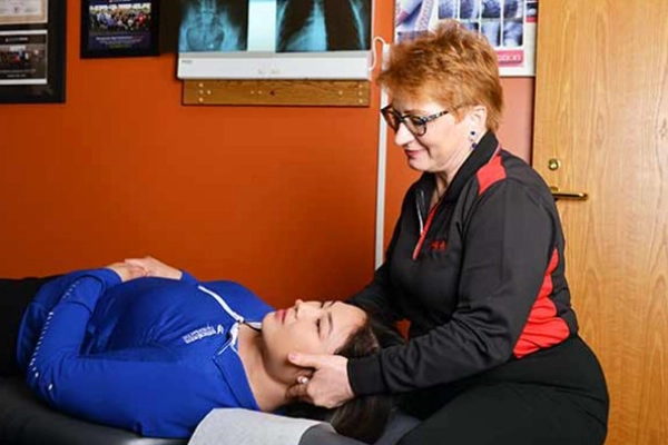 Chiropractor St Paul MN Trish Wolff Palpating Patient